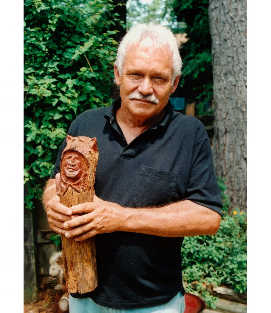 Chainsaw carver Jackie Woods of Kilmichael with a “mountain man” carving (all photos of Woods and his work by Wiley Prewitt for the Mississippi Arts Commission).