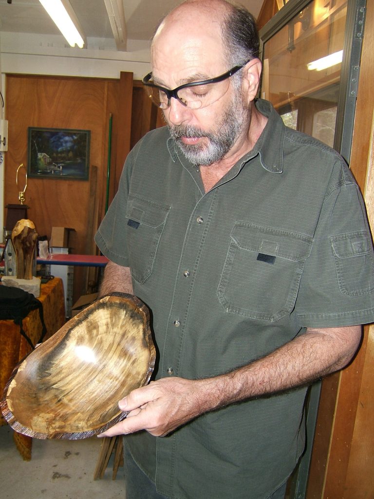 Terry Tjader and bowl with natural edges from popcorn tree, or Chinese tallow (photo by Chris Goertzen for the Mississippi Arts Commission).