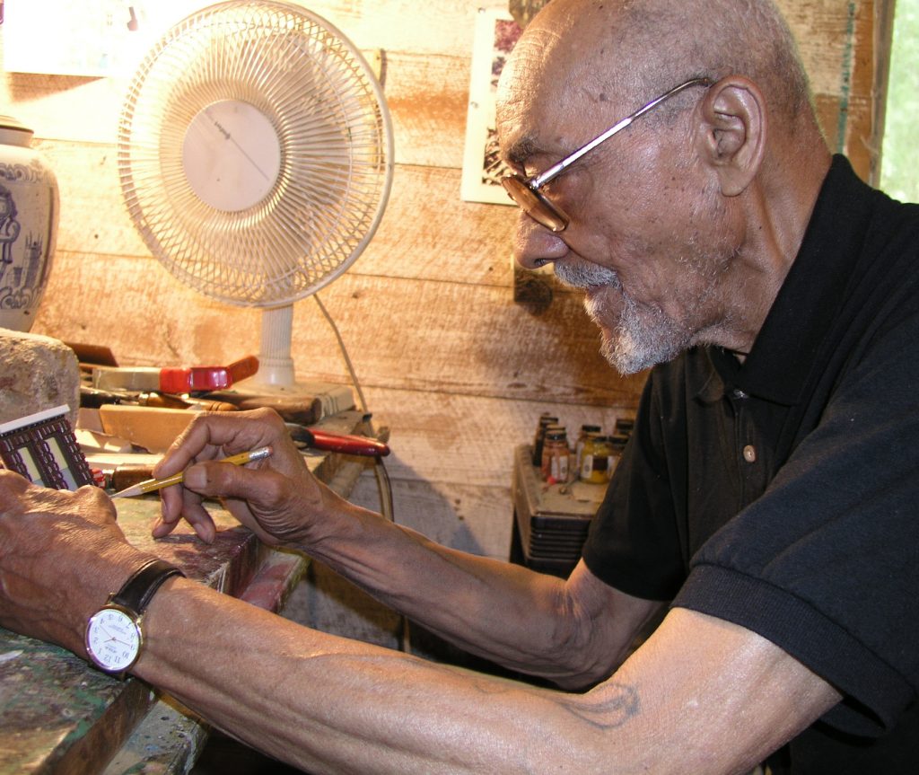 Edward Jones working on a specially commissioned miniature house in his workshop near Pattison, Mississippi.