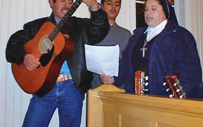 Sister Maria Theresa Rodriguez (r) and a local guitar player leading the singing at the service.