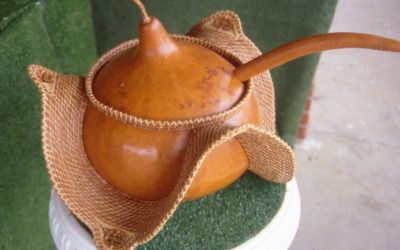 Punch bowl made from a large gourd with pine straw decoration attached. The dipper is also made from a gourd.