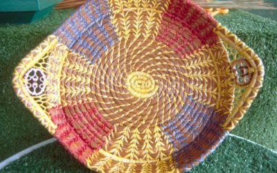 Small pines straw tray. Johnson tries to replicate quilt patterns on some of her trays by using different colors of raffia.