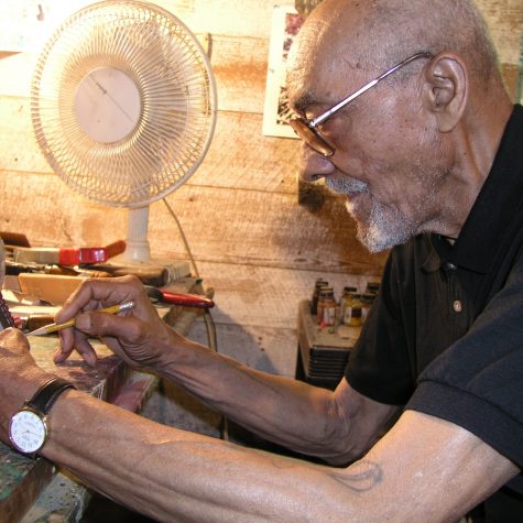 Edward Jones working on a specially commissioned miniature house in his workshop near Pattison, Mississippi.