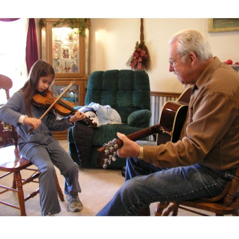 Old-time fiddler Charles T. Smith (right) working with student Ruby Jane Smith at his home in Tupelo in 2005.