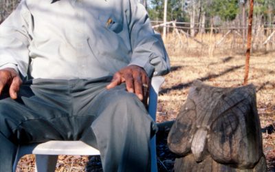 George Berry with a large version of his signature owl carving.